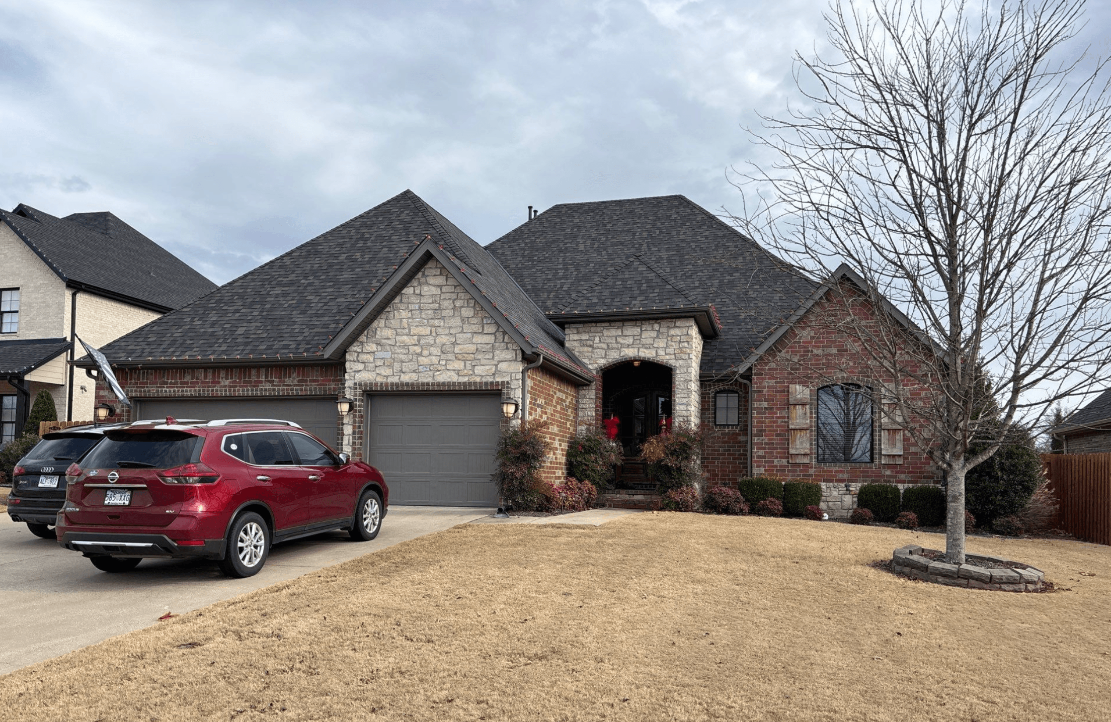 3,650 sq ft stone and brick home in Springdale with steep roof and Owens Corning Duration shingles in Black Sable