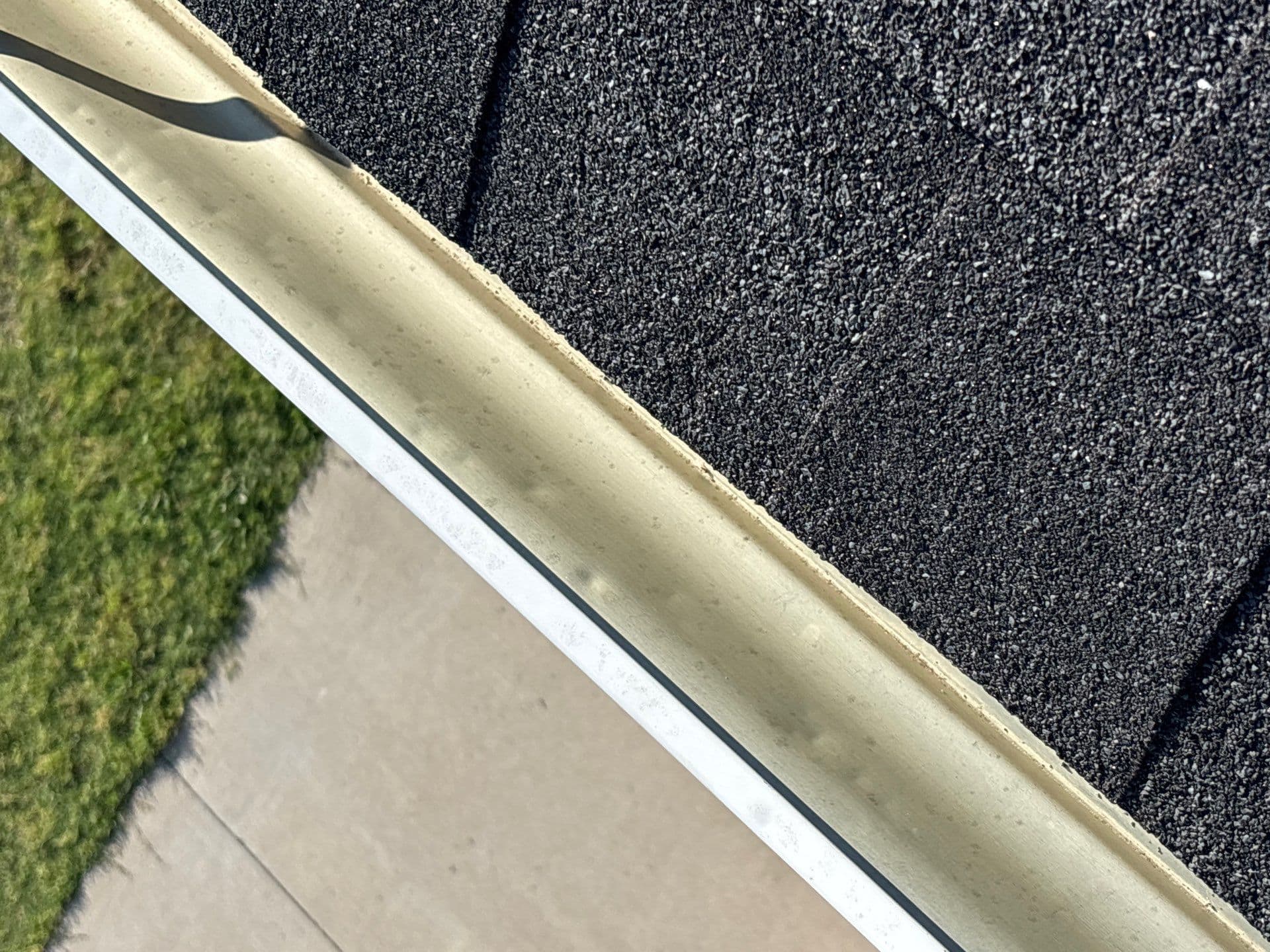 Hail damage on gutter system showing dents and impact marks