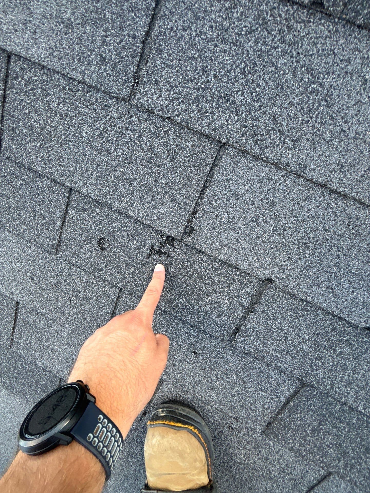 Wide angle view showing extent of hail damage on roof surface